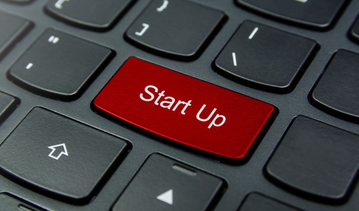 Business Concept: Close-up the Start Up button on the keyboard and have Red color button isolate black keyboard